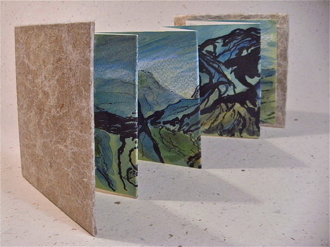 Annie's print Above Buttermere displayed in one of her handmade concertina books